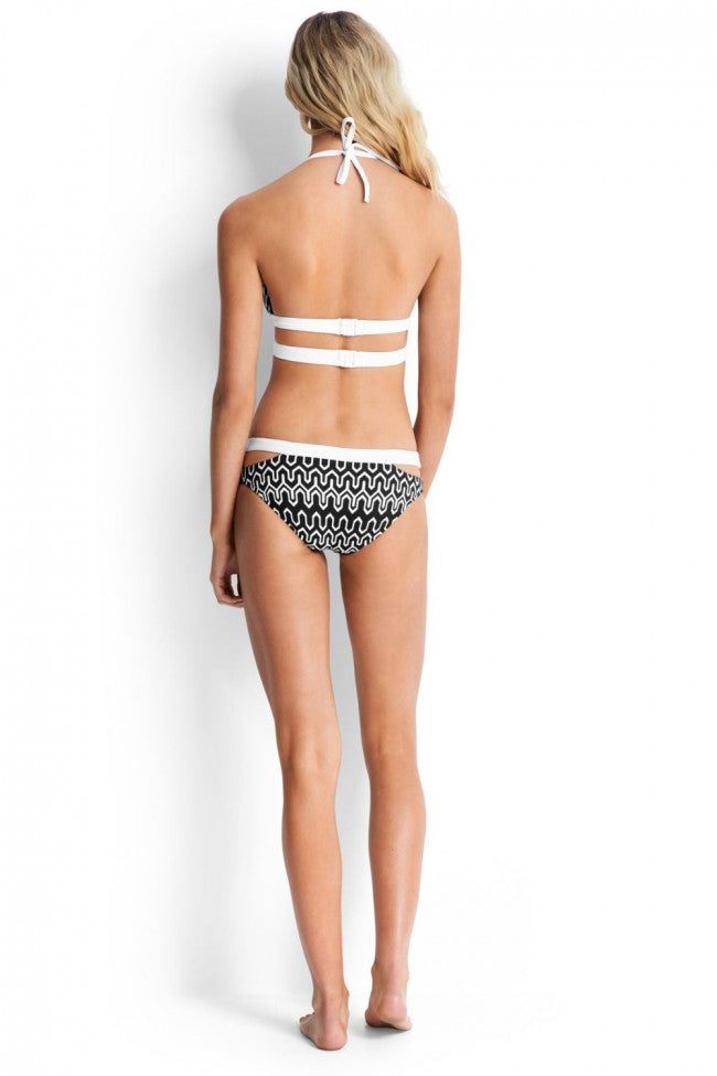 Create an eye-catching beach look with the Optic Wave Halter Bikini by Seafolly! This charming two-piece suit features a split band halter top with tie and clasp for a perfect fit and removable soft pads for customized comfort. The split band hipster bottoms have medium seat coverage for a flirty yet modest look. Wave hello to your new favourite swimsuit!    30620008/4032700