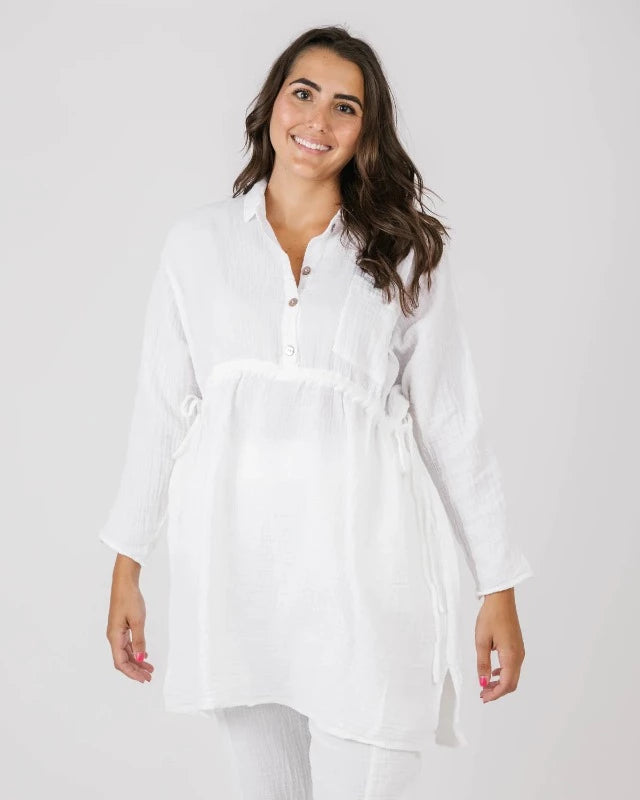 Look rad in the Shannon Passero Vina Top! This oversized, long-sleeve top features a half button closure, a convertible drawstring waist tie and pockets - a gal's gotta have her pockets. Throw it on over jeans or leggings for an effortless, yet chic look. BAM. Done!    5065