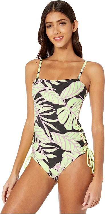 Hit the beach stylishly in the Tropic Arista One Piece! Features a bandeau bodysuit with soft cups and removable straps. Back hook straps, a signature striped bottom, and tie sides. Moderate backside coverage with a reversible Maajical surprise. Model wearing a Small.