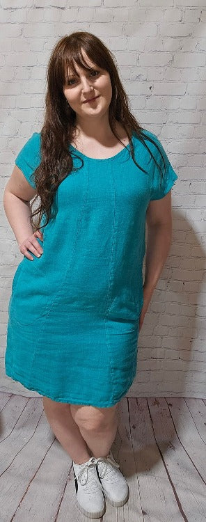 Round-about neckline, cute lil' cap sleeves, pockets for your goodies, elastic details in the back - this 100% Linen dress was made to impress!