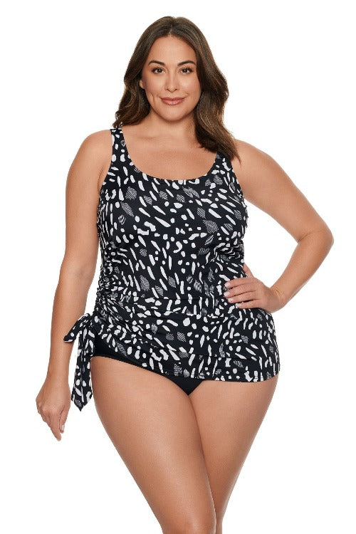 Be the belle of the beach in the Penbrooke Women's Jungle Dot Tie Faukini One Piece Swimsuit. Instantly create a flattering figure with the adjustable straps and side tie, tummy control and soft cups. Plus, this one-piece suit features a conservative cut bottom, so you can feel secure even when going for a dip! Keep it cute with the dot overlay - you won't find a more stylish way to make a splash!