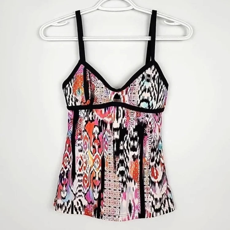 Summer days are calling! Enjoy the sunny season in this must-have tankini from Beach Gypsy. The sultry, boho-inspired print and contrasting black binding make a statement, while removable cups, side boning, and a cut-out front detail provide all the support and shape you need. The medium seat coverage retro pant will have you looking head-to-toe vintage chic! Get ready to soak up some sun!     30623249/4006065