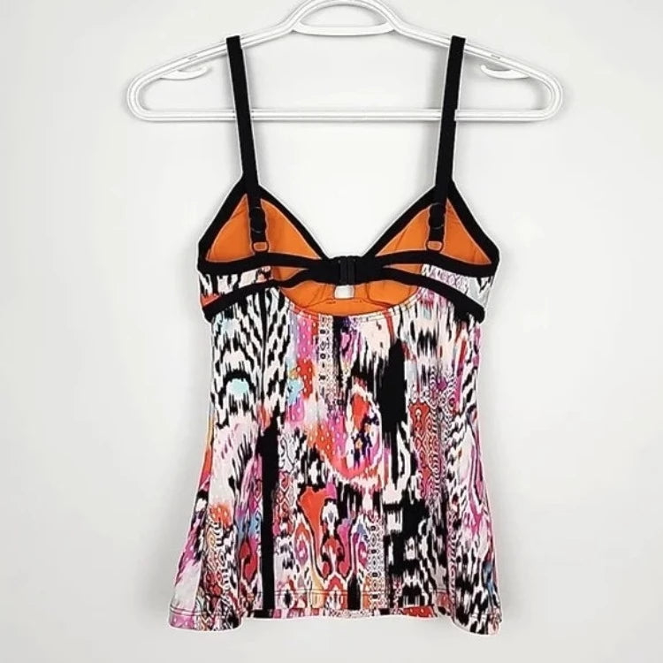 Summer days are calling! Enjoy the sunny season in this must-have tankini from Beach Gypsy. The sultry, boho-inspired print and contrasting black binding make a statement, while removable cups, side boning, and a cut-out front detail provide all the support and shape you need. The medium seat coverage retro pant will have you looking head-to-toe vintage chic! Get ready to soak up some sun!     30623249/4006065