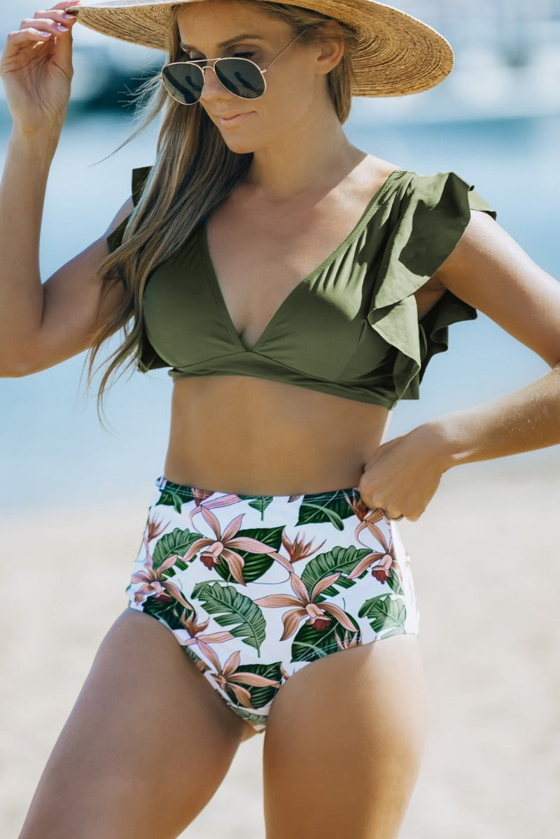 Show off your figure in this oh-so-gorgeous Frill Top High Waist Bikini. With a ruffle sleeve, fixed back, plunge neckline, and full seat coverage, this sexy two-piece is perfect for a luxe beach day. With medium support up to a size E cup, you'll have everything you need to slay all summer long. Yaaas!    SW43335-9, SW433851-6