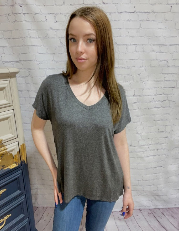 This basic V-neck t-shirt is anything but basic! With a drop shoulder, side slits, a hi-lo hem, and short sleeves, it's the perfect combination of chic and comfy. Dress it up with a skirt for a night out or keep it casual with some leggings for the ultimate chill look. We're in love!       P9248928