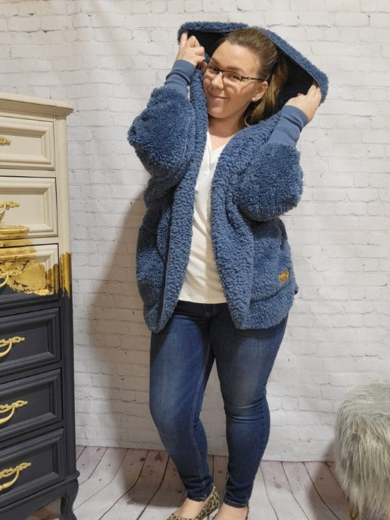 Greet the new season in style with the Sherpa Cardigan! Crafted with signature cotton candy fabric, this cozy cardi fits you like a glove - no matter your size. Slide it on and feel as comfy and cuddly as when you take a bite of a plushy marshmallow. Throw it on and look cute AF as you strut your stuff around town. #1 size fits all!