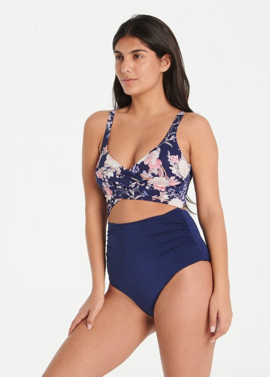 Every Sunday, this iconic best seller wraps you in luxury and confidence! With a design that takes the best of both bikinis and one-pieces, you can own one in every color. Its navy and purple floral print flatters all shapes, while removable cups, inner support, tummy control, and regular coverage offer maximum comfort. Dive into the euphoria of this piece!