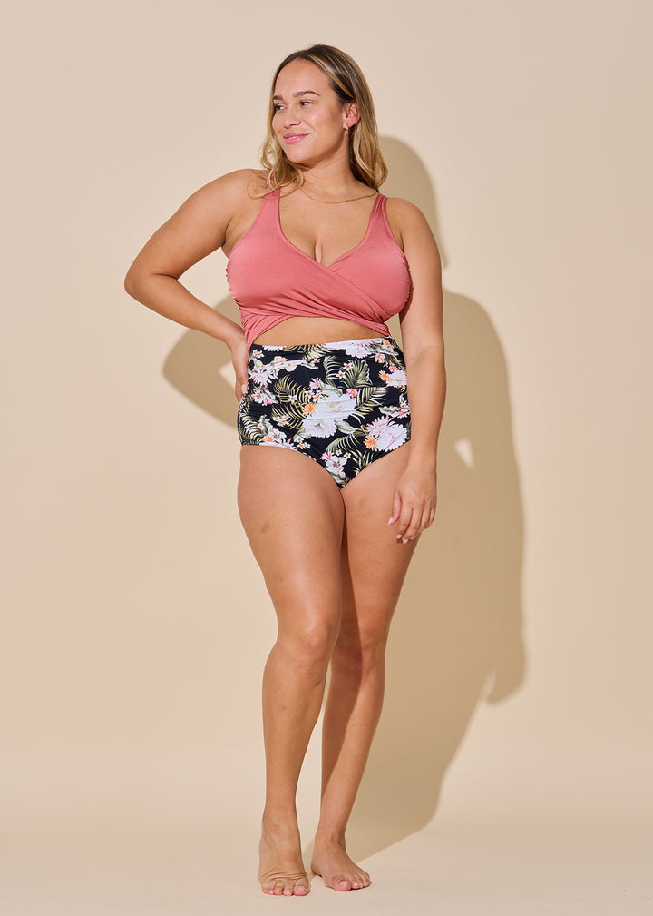 Everyday Sunday Peaceful Floral Wrap One Piece  The hourglass shape-maker! Be the best dressed on the beach in this best selling, size inclusive suit. This flattering wrap top plus classic cut bottoms with cute cut outs accentuates your sexy curves while offering front tummy control in a beautiful floral pattern.