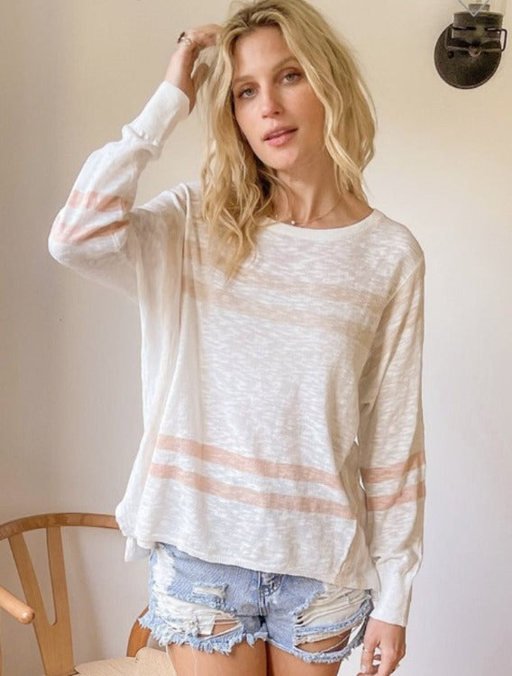 This weightless wonder is 100% cotton-crafted and ideal for those mid-layer needs when sunshine reigns but the breeze is brisk with these wild winds. Round-necked with an oversized fit, it's tinged with ivory, taupe and blush tones.