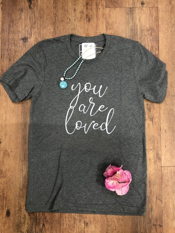 Take your basic t-shirt to the next level with the Blonde Ambition You Are Loved Boyfriend Tee! Boasting comfortable cotton and polyester, this unisex Tee will have you feeling like you can conquer the world...all while being reminded that you're loved. It's the best of both worlds!