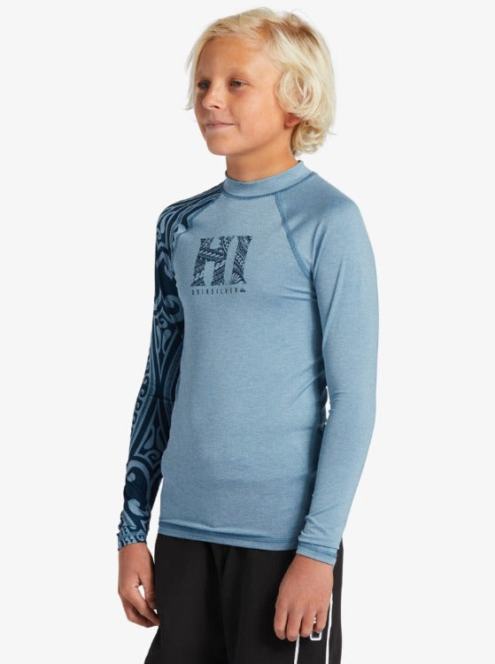 Your grom will shred the gnar in style with this 8-16 Boy's UPF 50+ Long Sleeve Surf Tee. Features a "Surfs Up" tattoo detail, summer fun styling, and eco-conscious fabric with moisture-wicking properties. Enjoy 8-hour surf sessions with built-in sun protection and chlorine resistance. Mock neck with snug fit and long sleeves.     EQBWR03238