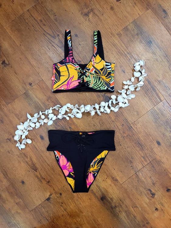 Maaji Lace Up Bikini Set  This beautiful Maaji has a reversible lace up bralette top and a reversible lace up high waisted with a cheeky cut bottom. It also comes with soft cups and there are four-ways this suit can be worn.Splash into summer with this eye-catching Maaji swimsuit! The reversible black and tropical two-piece is designed with a jaw-dropping lace-up v-neck bralette and high-waisted cheeky bottom, meaning you can rock it four different ways. Let the fun begin!