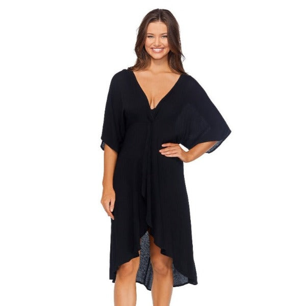 Escape to paradise with Raisin's Paradise Cover Up! This blissful boho design is just the thing to take your beach style up a notch - it's semi-sheer, with a high-low design, twist front detail, plunge v-neckline, and 3/4 flounce sleeve. It's the perfect way to make a statement and get lost in beachy vibes! Simmer in the sun in style!     J710037 